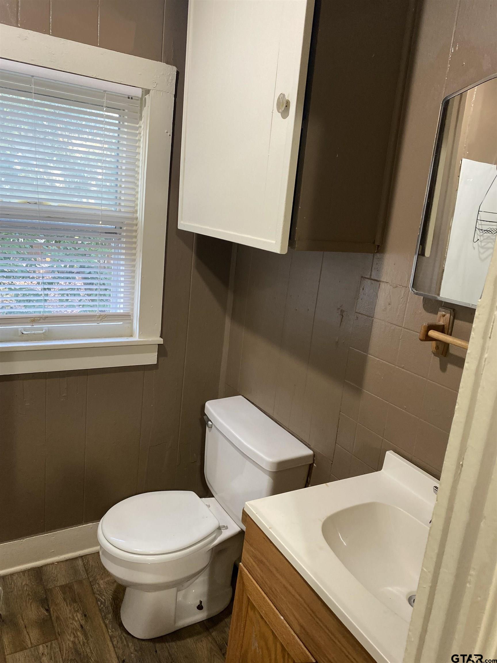502 3rd Street Quitman, TX 75783 - Photo 14 of 22 a white toilet sitting next to a bathroom sink