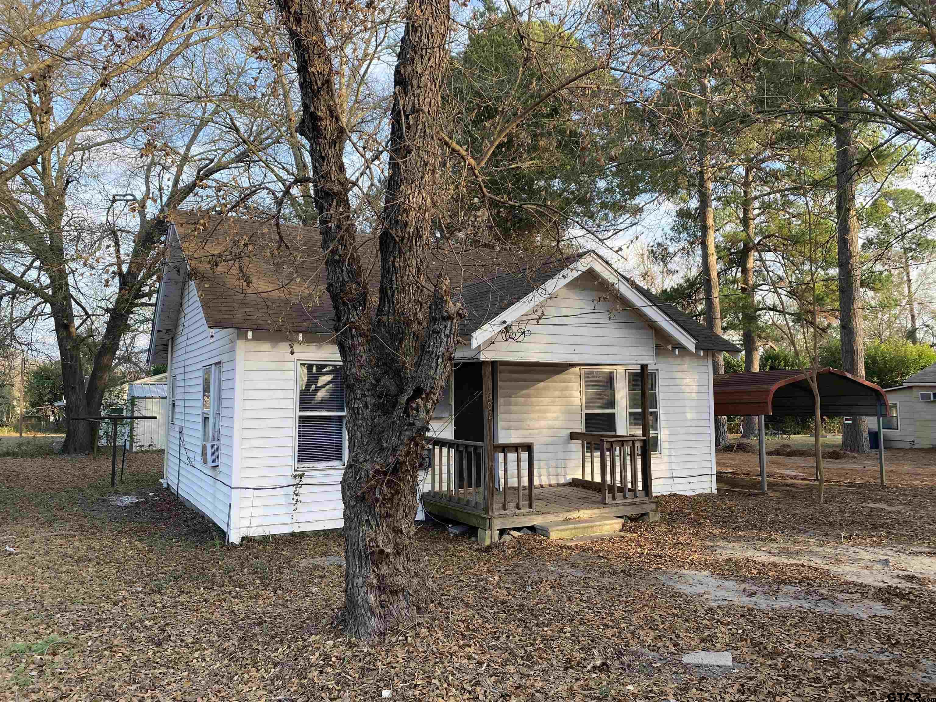502 3rd Street Quitman, TX 75783 - Photo 2 of 22 a front view of a house with a yard and large tree
