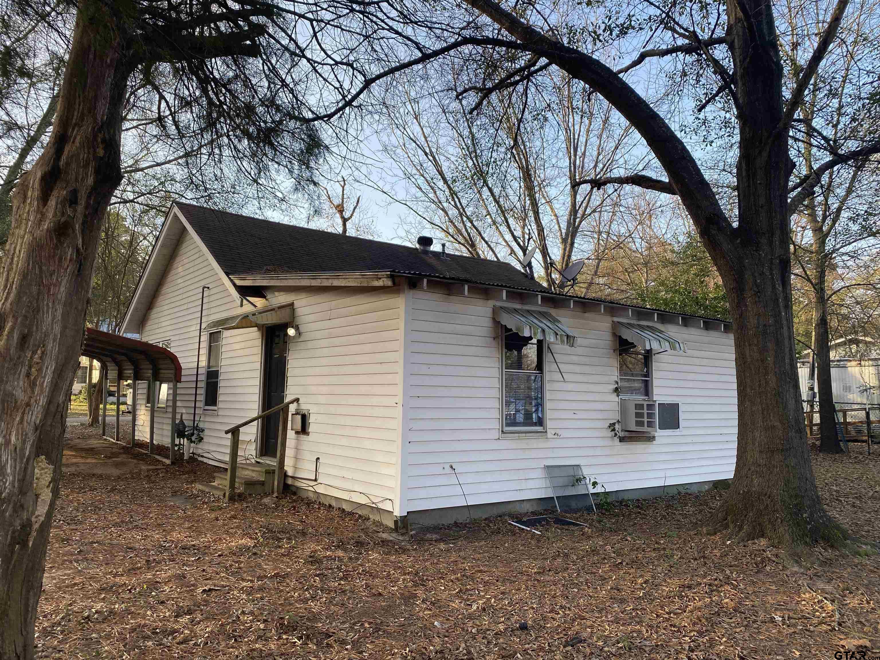 502 3rd Street Quitman, TX 75783 - Photo 3 of 22 a view of a house with a yard and tree