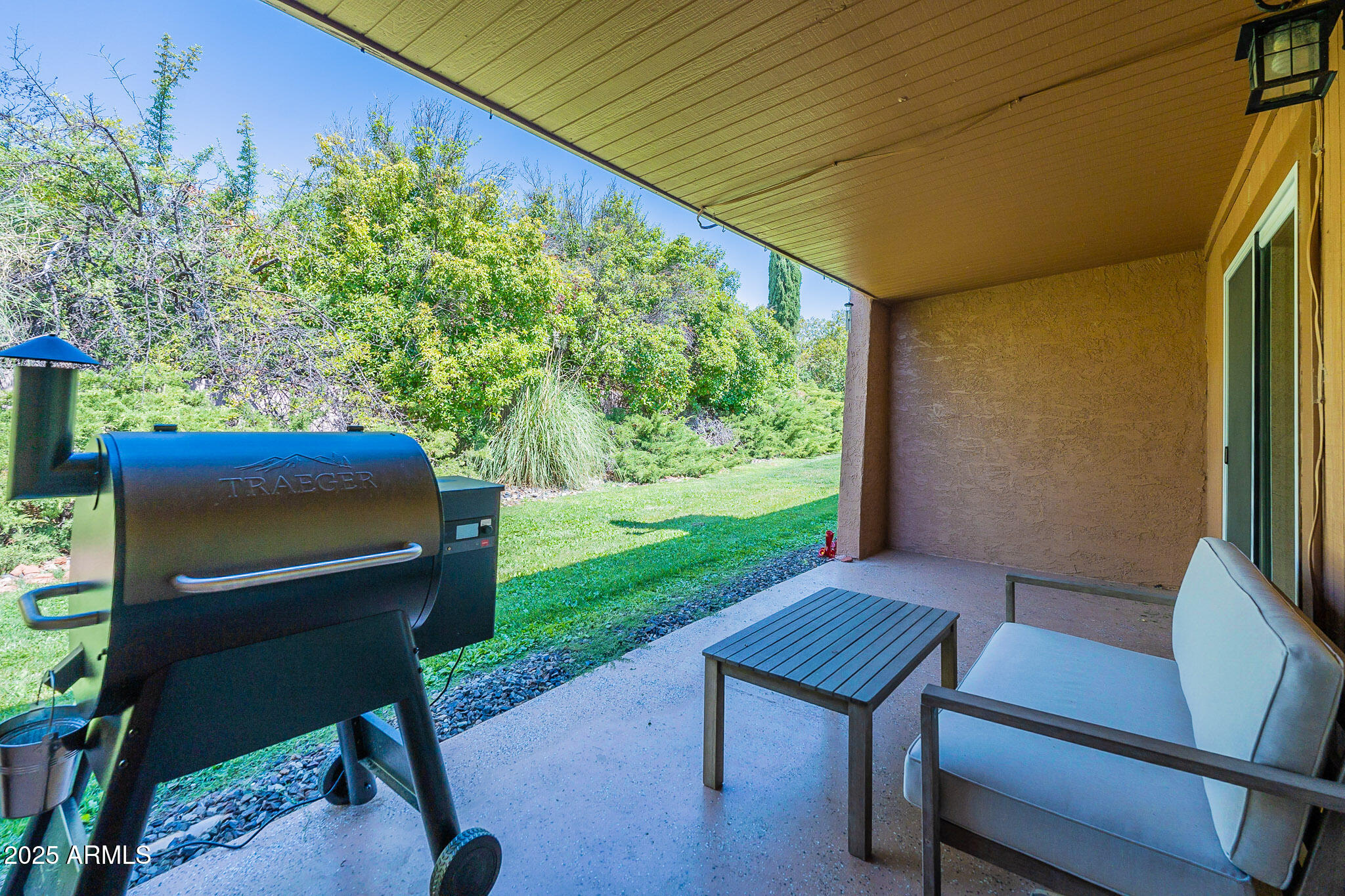 130 Castle Rock Road, Unit 100 Sedona, AZ 86351 - Photo 31 of 36 a backyard of a house with table and chairs
