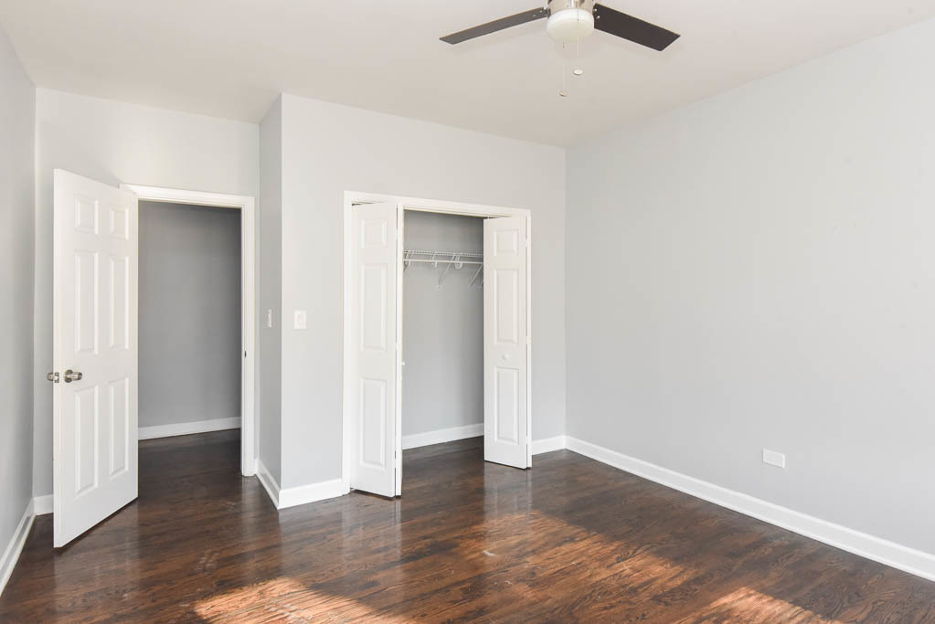 3301 North Harding Avenue, Unit 1E Chicago, IL 60618 - Photo 15 of 21 an empty room with wooden floor and ceiling fan