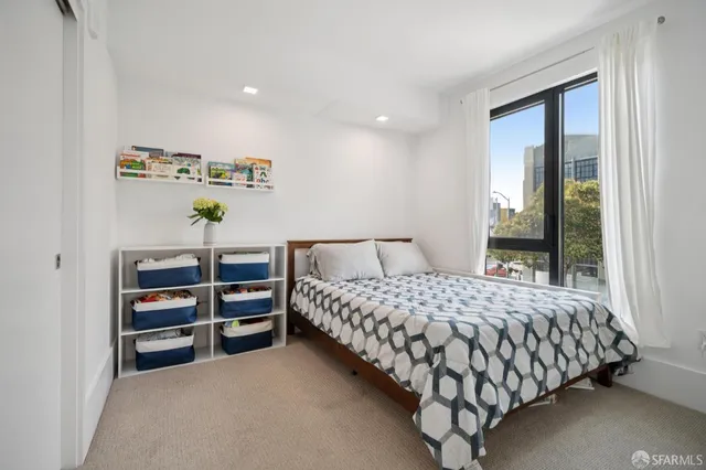 a bedroom with a large bed and a window