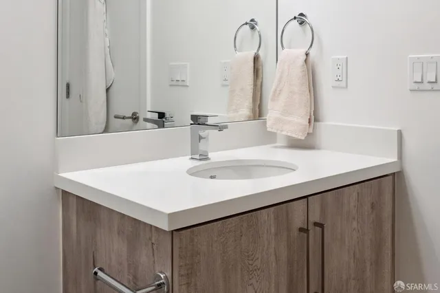 a bathroom with a sink a toilet and mirror