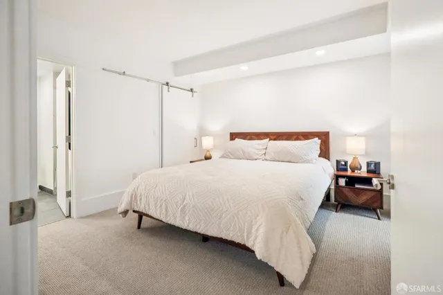 a bedroom with a bed and a bathroom