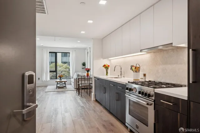 a kitchen with stainless steel appliances granite countertop a stove and a refrigerator
