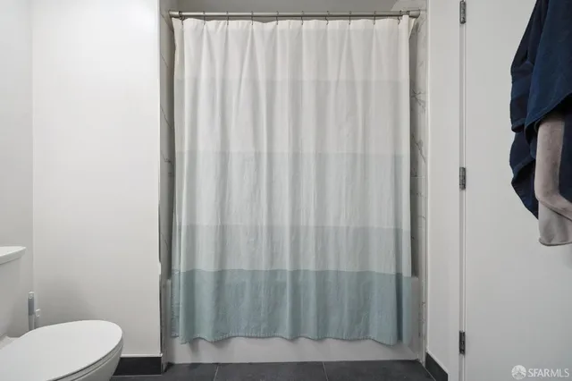 a living room with furniture a flat screen tv and a window