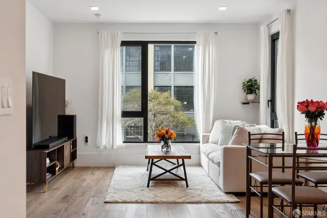 a view of backyard with outdoor seating and plants