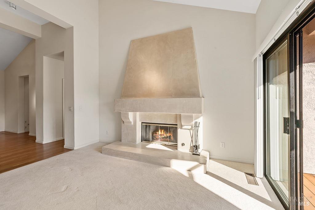 6271 Meadowstone Drive Santa Rosa, CA 95409 - Photo 7 of 24 a living room with a fireplace and a floor to ceiling window