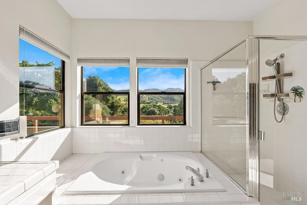 6271 Meadowstone Drive Santa Rosa, CA 95409 - Photo 10 of 24 a bathroom with a tub and a shower