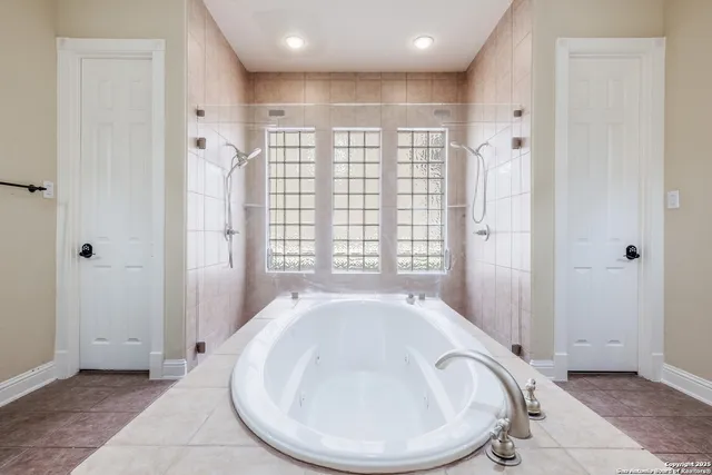 a bathroom with a bathtub and a shower