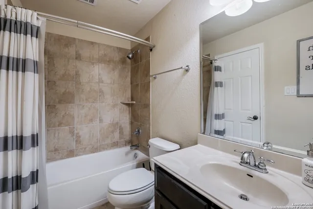 a bathroom with a sink toilet tub and shower
