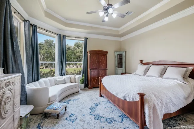 a spacious bedroom with a bed and glass window