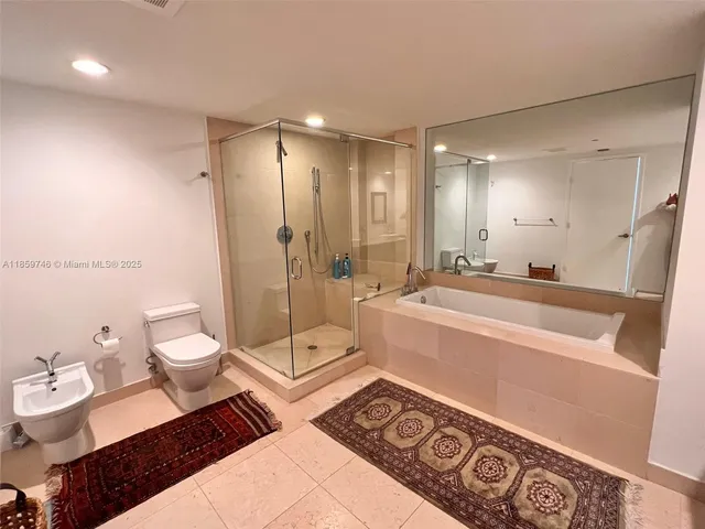 a spacious bathroom with a double vanity sink toilet and a shower