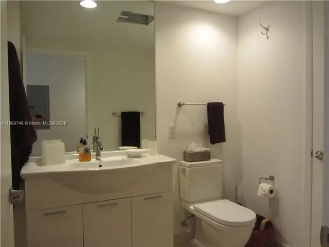 a bathroom with a sink toilet and mirror