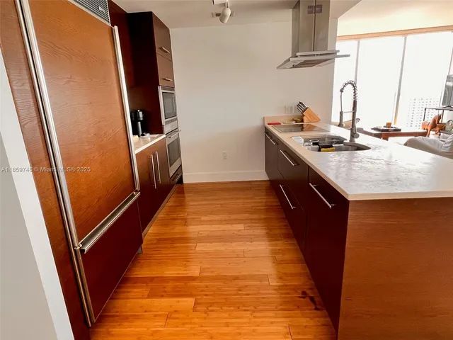 a kitchen with sink window and refrigerator