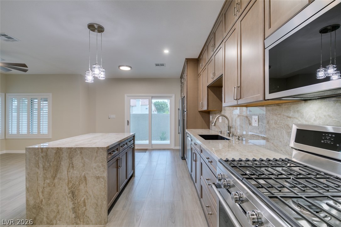 540 Sutters Mill Road Henderson, NV 89014 - Photo 30 of 46 This sleek kitchen features an inviting island, perfect for culinary endeavors and casual dining.