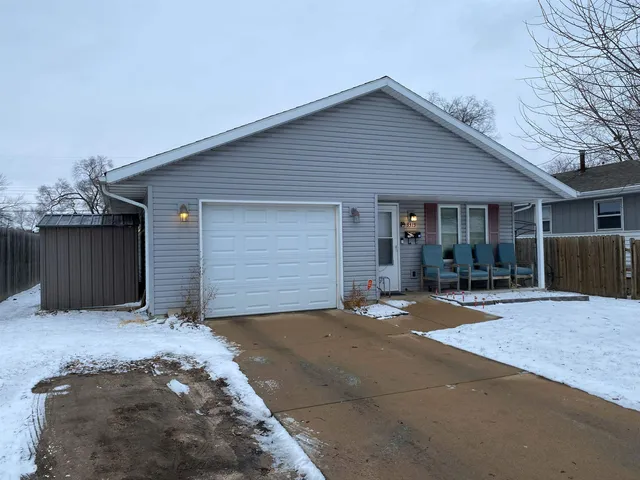a front view of house with yard outdoor seating and garage