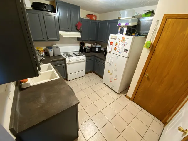 a kitchen with a refrigerator and washer