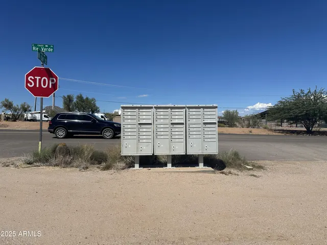 a view of a wooden wall with an trees in the background