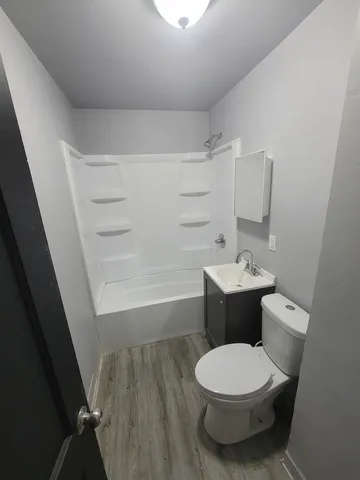 a bathroom with a toilet a sink and bathtub