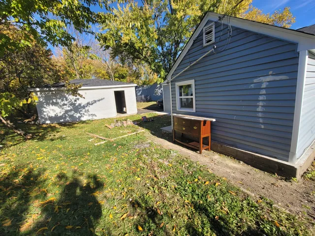 a backyard of a house with yard and outdoor seating