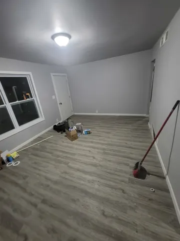a view of a hardwood floor and staircase