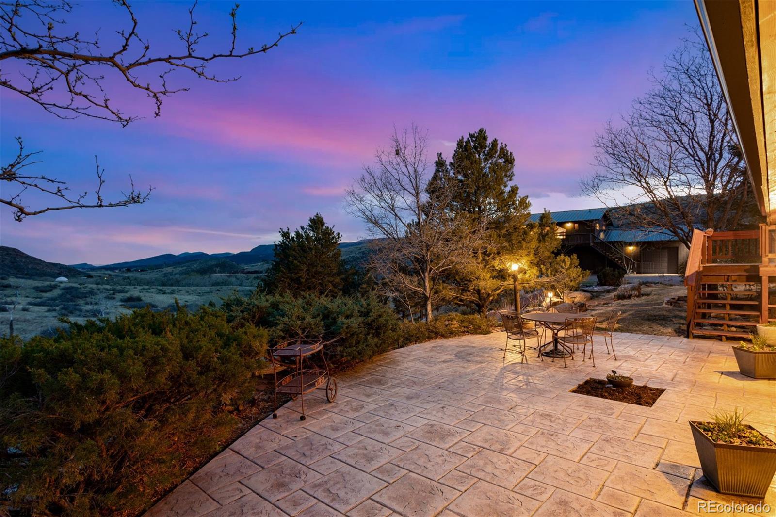 7050 Milner Mountain Ranch Road Fort Collins, CO 80526 - Photo 11 of 50 a view of a backyard with sitting area