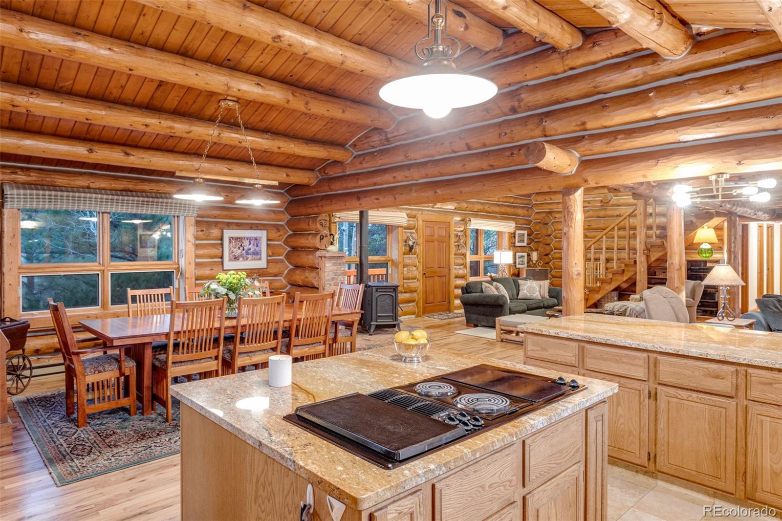 7050 Milner Mountain Ranch Road Fort Collins, CO 80526 - Photo 26 of 50 a large kitchen with a table and chairs