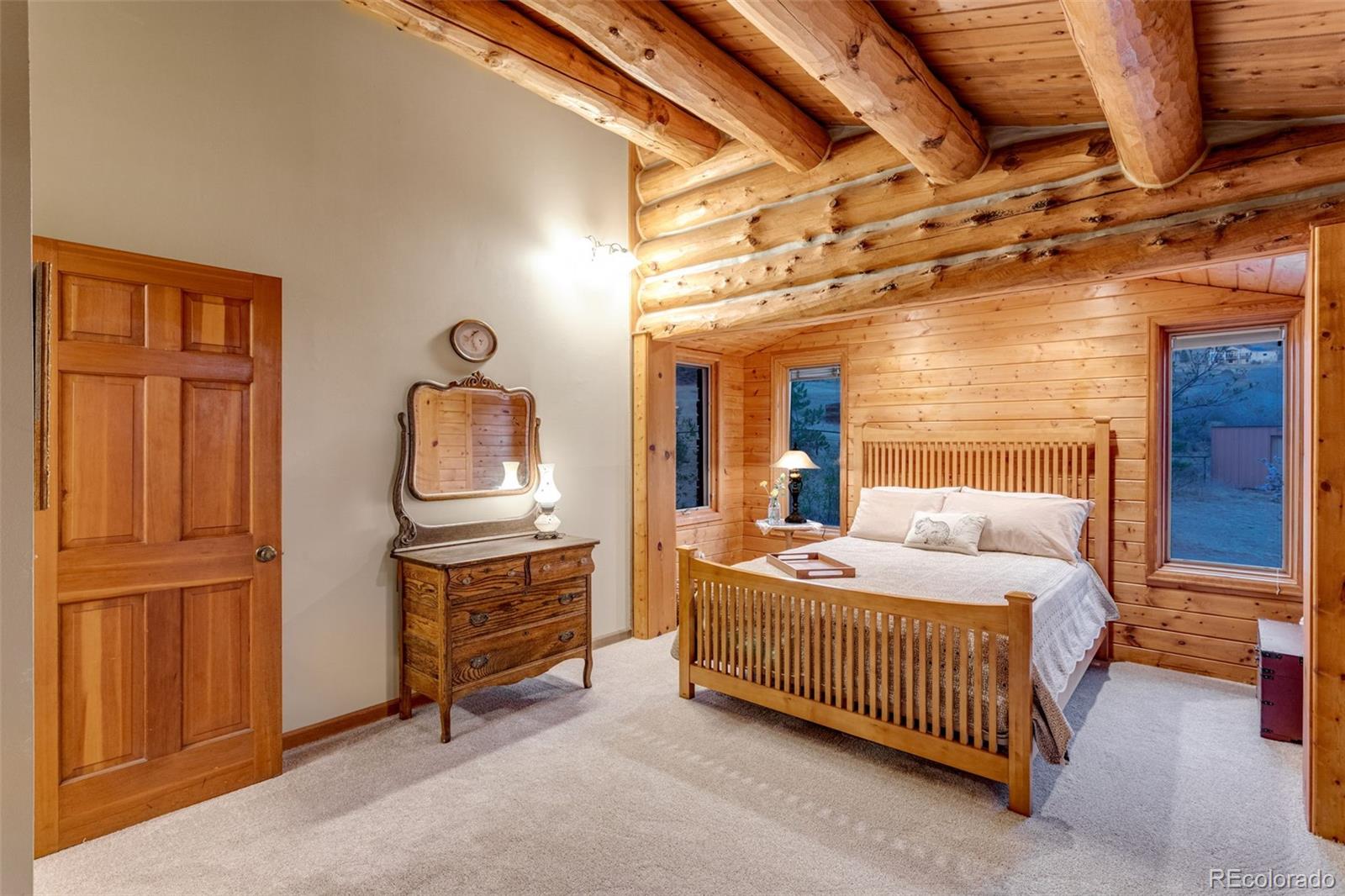 7050 Milner Mountain Ranch Road Fort Collins, CO 80526 - Photo 27 of 50 a bedroom with a bed and wooden floor