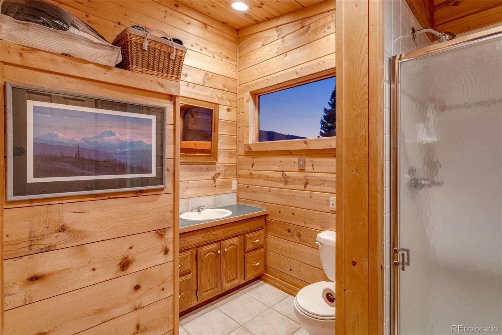 7050 Milner Mountain Ranch Road Fort Collins, CO 80526 - Photo 41 of 50 a bathroom with a toilet sink and mirror