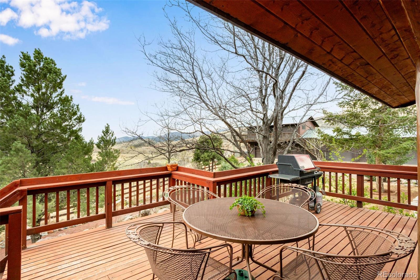 7050 Milner Mountain Ranch Road Fort Collins, CO 80526 - Photo 10 of 50 a view of a roof deck with wooden fence and floor