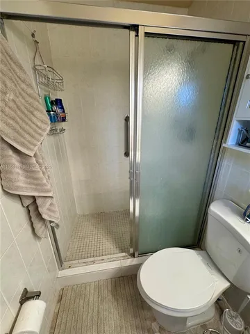 a bathroom with a toilet and a shower