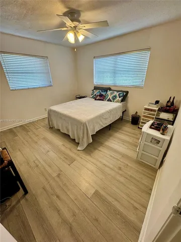 a spacious bedroom with a bed and a chandelier