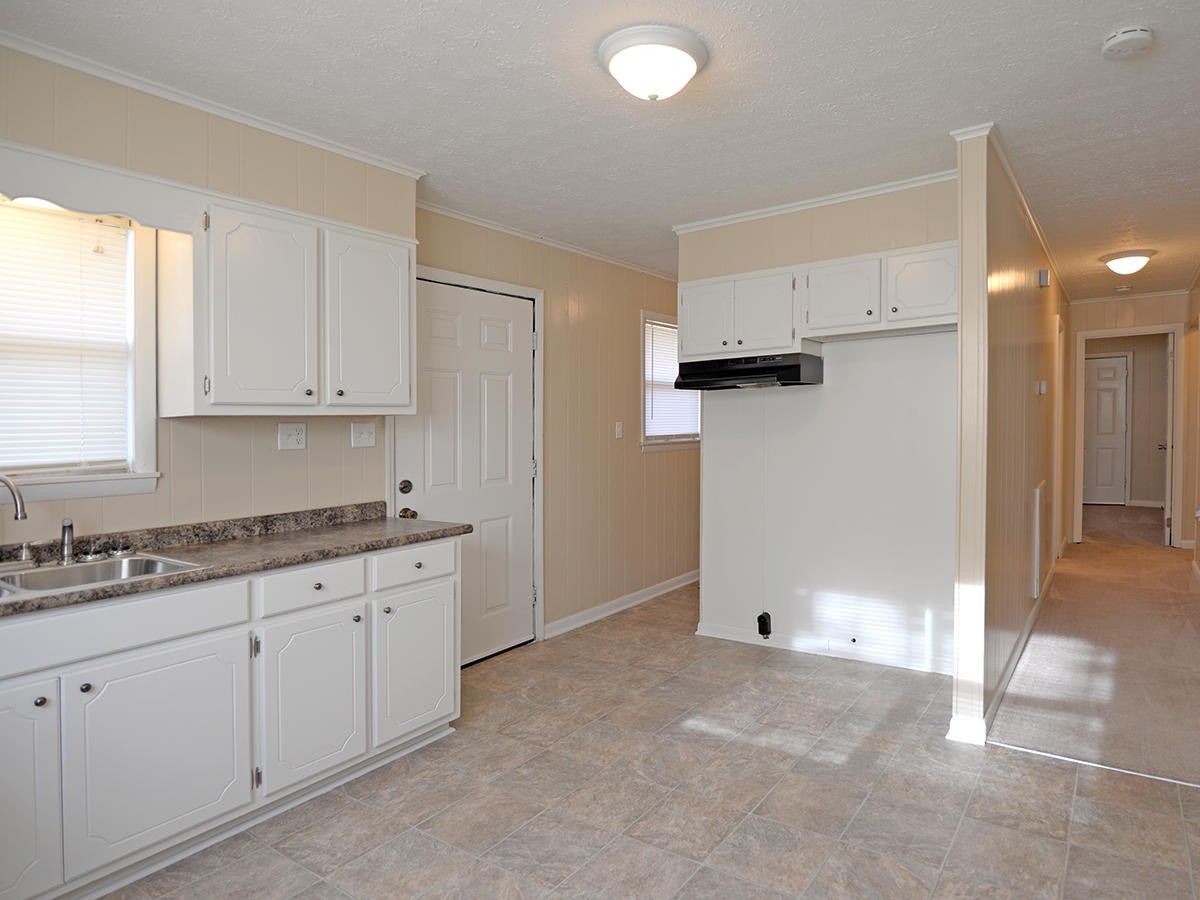234 Evans Road Kingston, TN 37763 - Photo 5 of 12 a kitchen with granite countertop white cabinets and white appliances