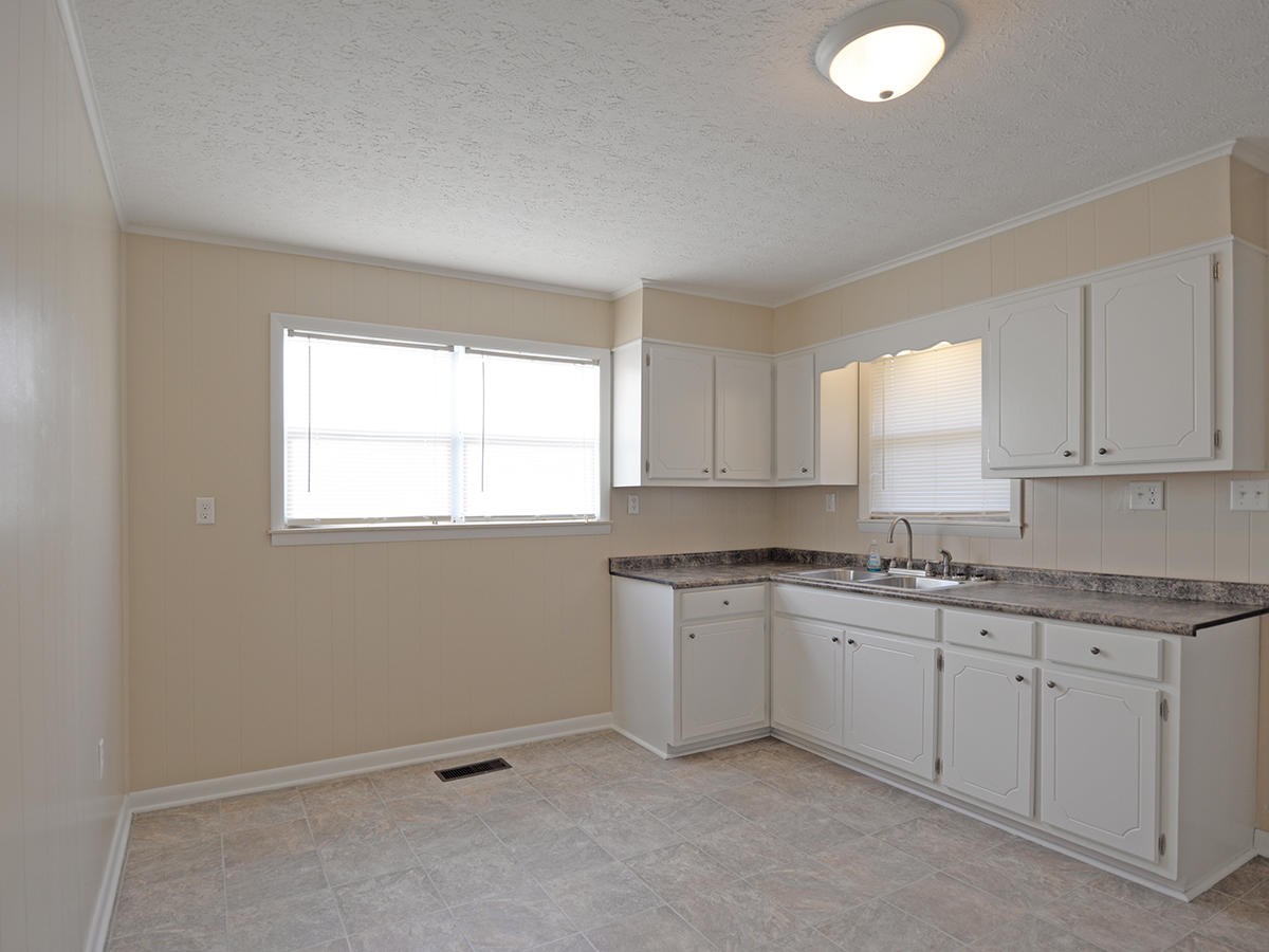 234 Evans Road Kingston, TN 37763 - Photo 6 of 12 a kitchen with a sink cabinets and window