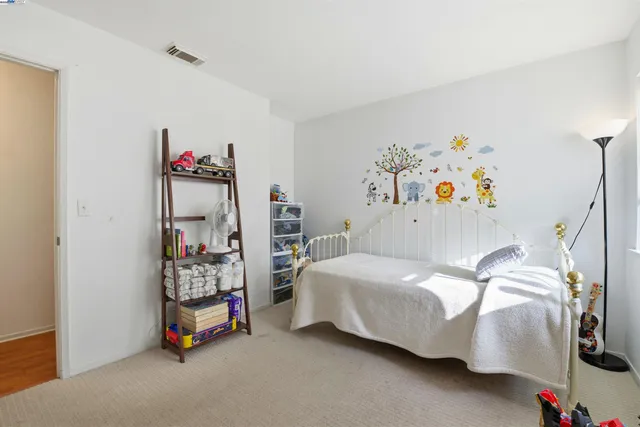 a bedroom with bed and book shelf