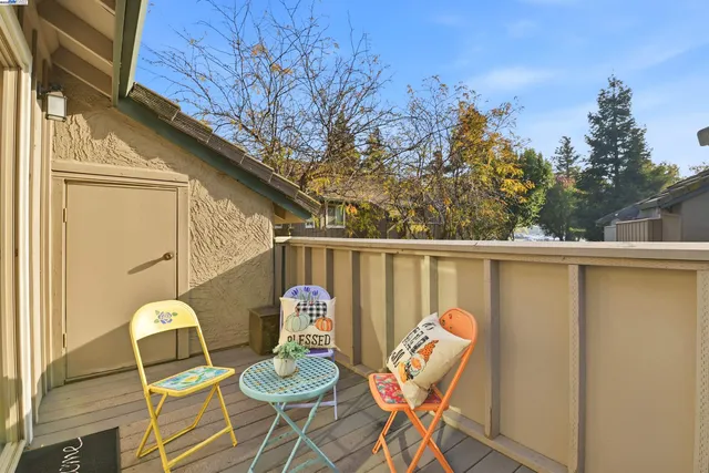 a view of a chairs and table in the balcony