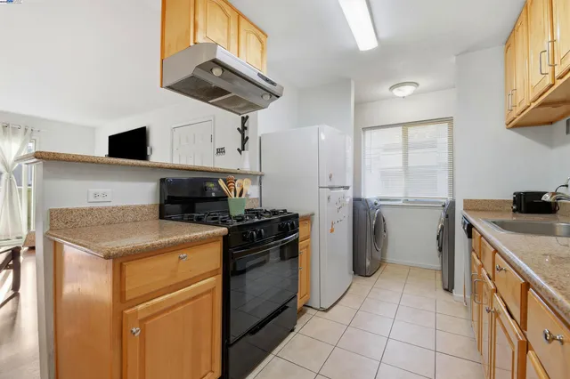a kitchen with a stove cabinets and refrigerator