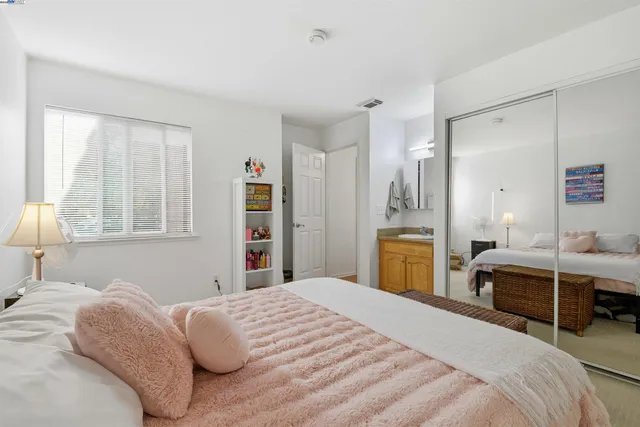 a bedroom with a bed and a view of bedroom