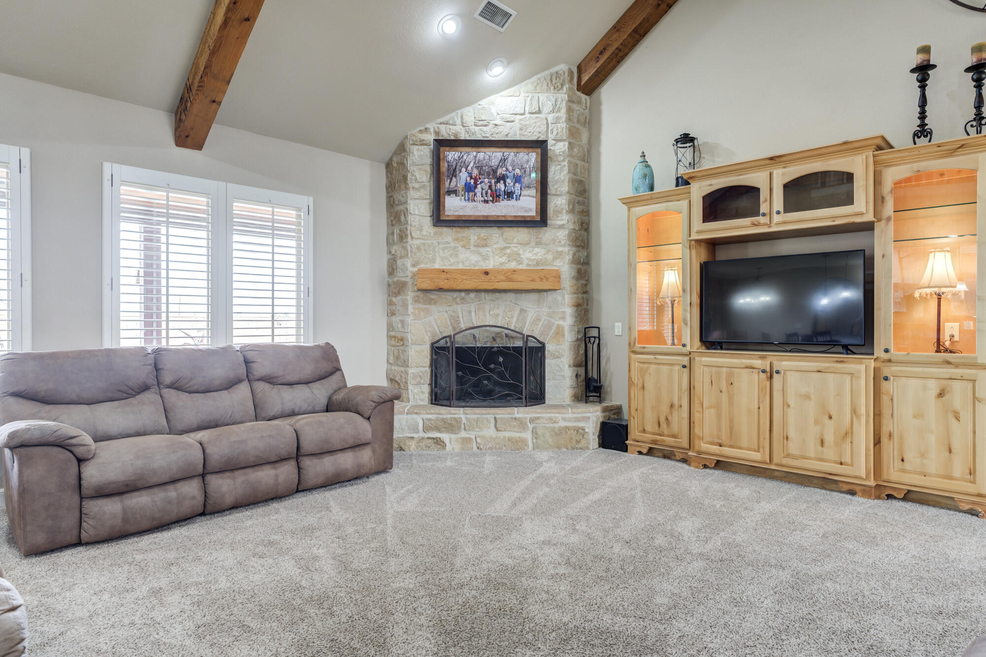 3206 County Road 7610 Lubbock, TX 79423 - Photo 15 of 93 a living room with furniture and a flat screen tv