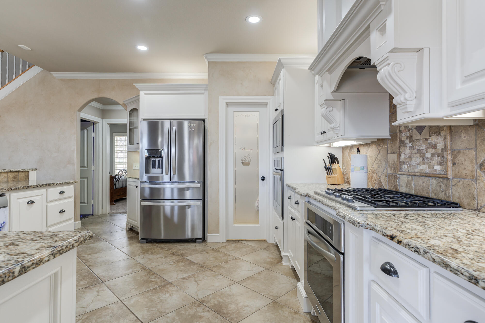 3206 County Road 7610 Lubbock, TX 79423 - Photo 20 of 93 a kitchen with stainless steel appliances granite countertop a stove a refrigerator and a cabinets