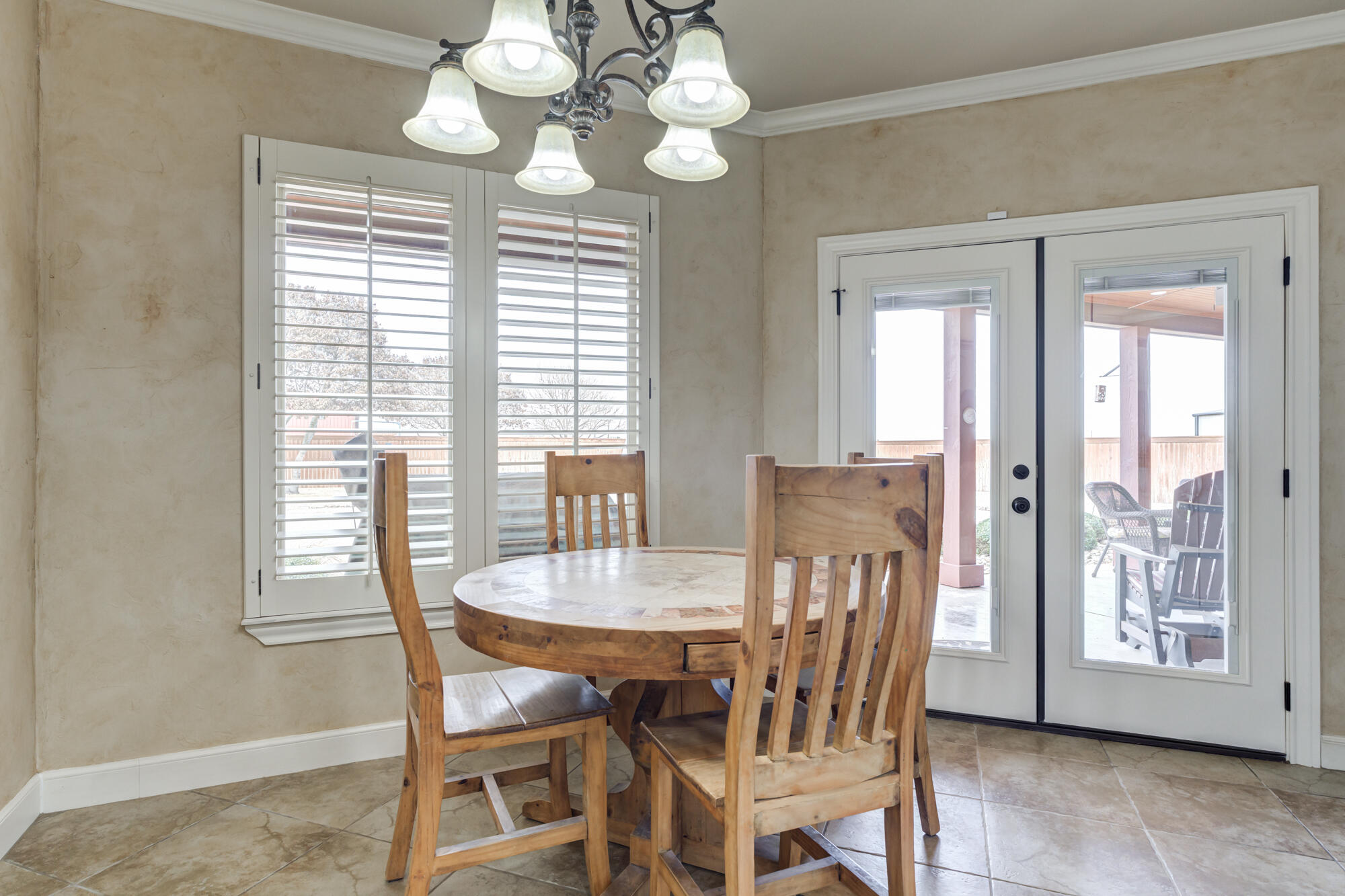 3206 County Road 7610 Lubbock, TX 79423 - Photo 22 of 93 a view of a dining room with furniture wooden floor and chandelier