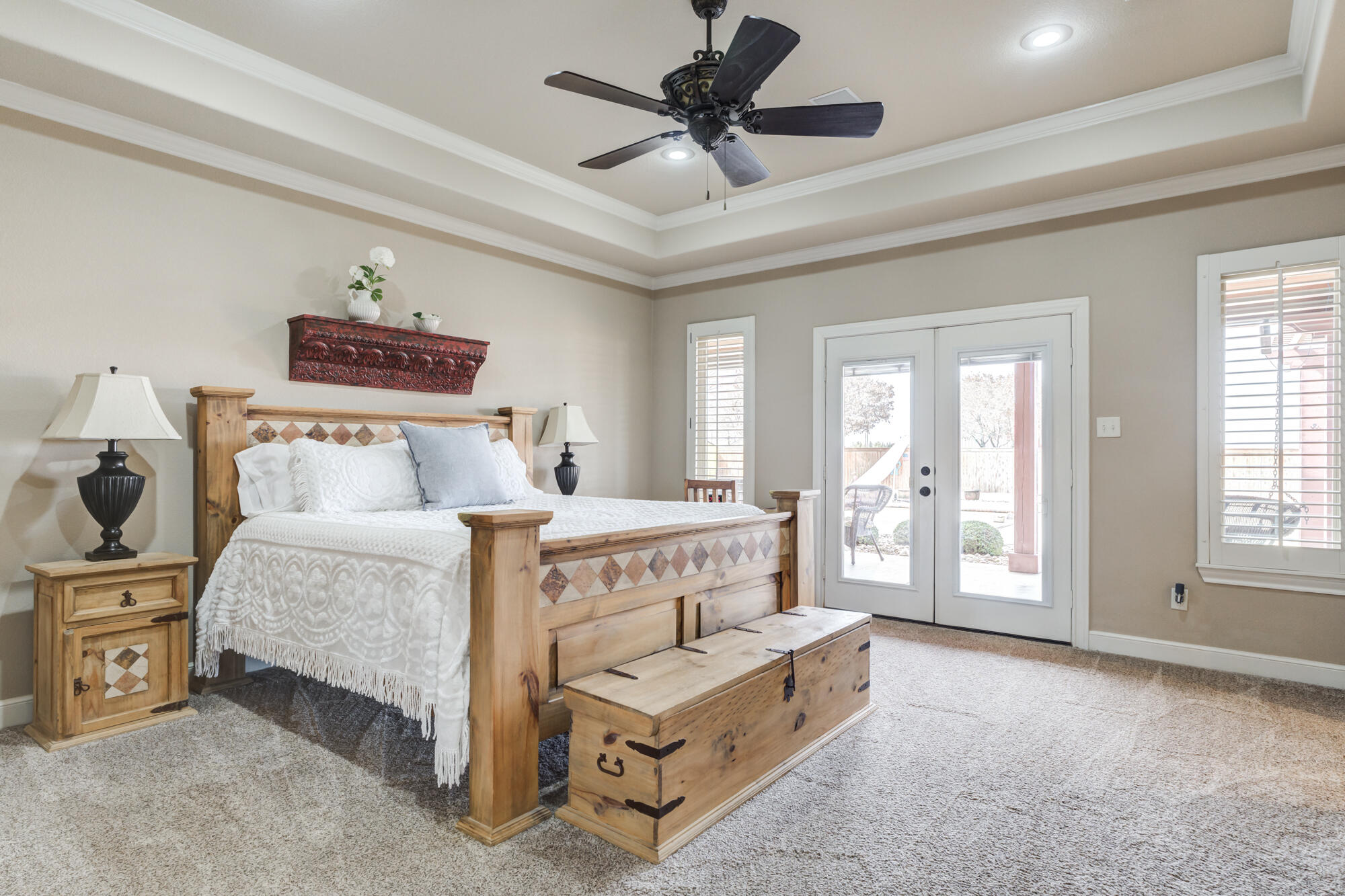 3206 County Road 7610 Lubbock, TX 79423 - Photo 27 of 93 a spacious bedroom with a bed and a chandelier