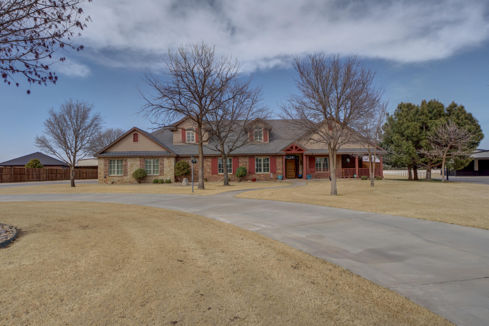 3206 County Road 7610 Lubbock, TX 79423 - Photo 3 of 93 a front view of a house with a garden