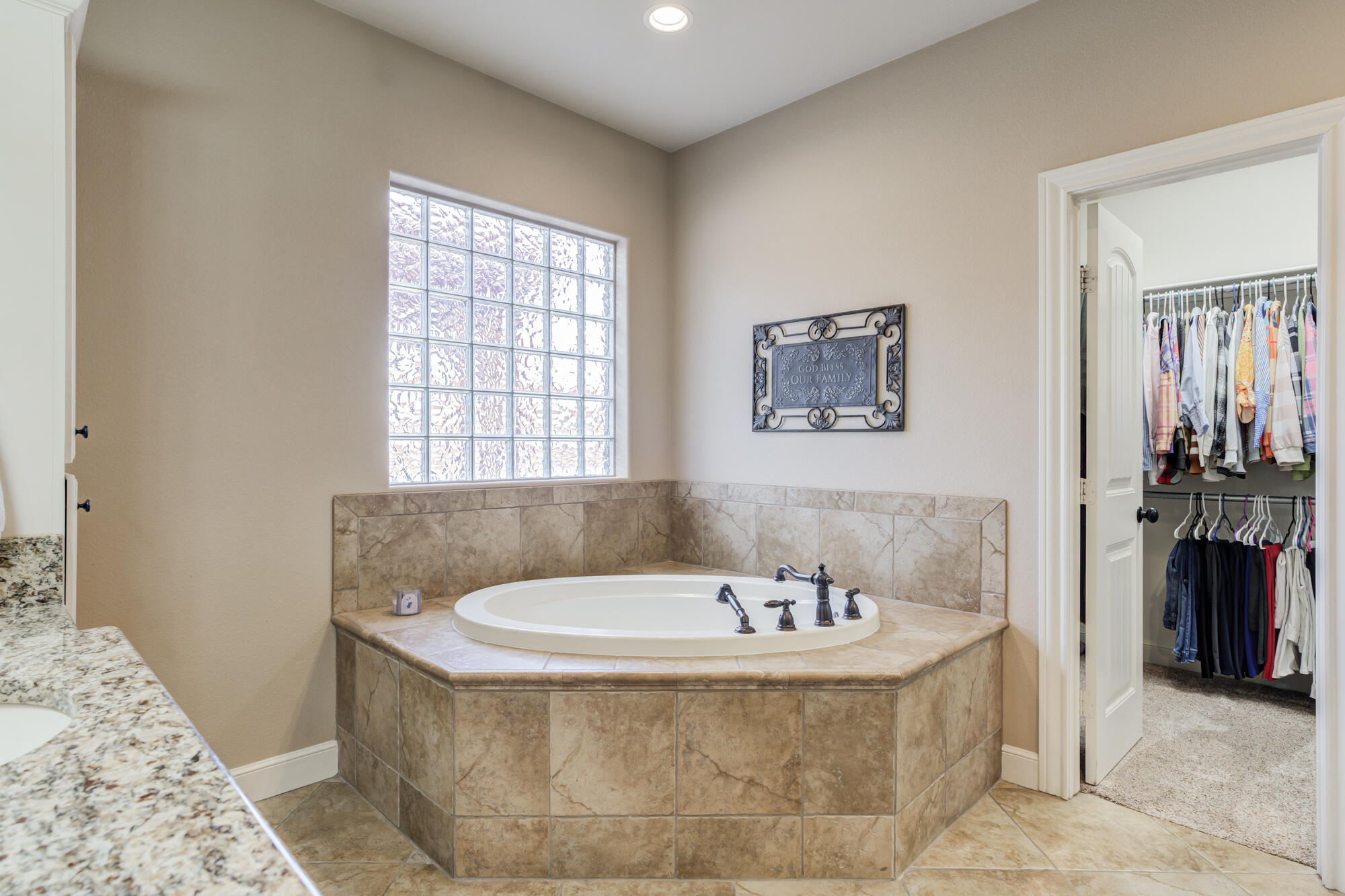 3206 County Road 7610 Lubbock, TX 79423 - Photo 32 of 93 a bathroom with a tub and a window