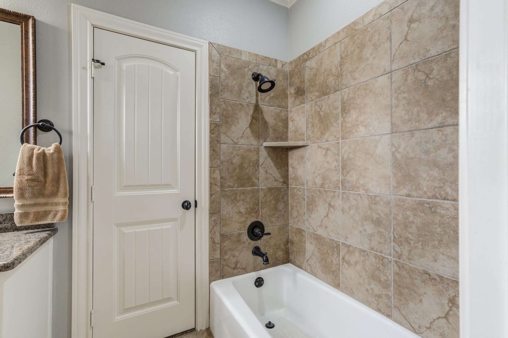 3206 County Road 7610 Lubbock, TX 79423 - Photo 43 of 93 a bathroom with a tub a sink and a shower