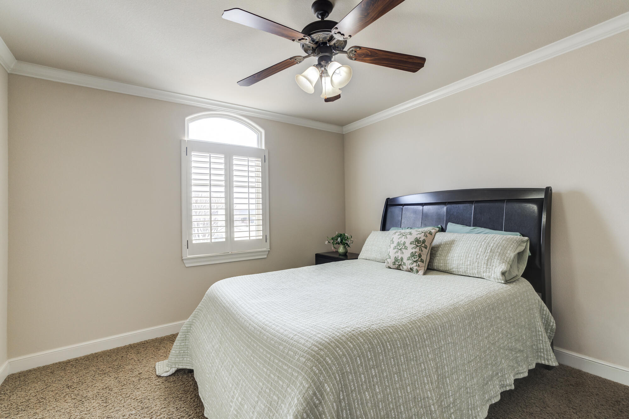 3206 County Road 7610 Lubbock, TX 79423 - Photo 46 of 93 a bedroom with a bed and a chandelier