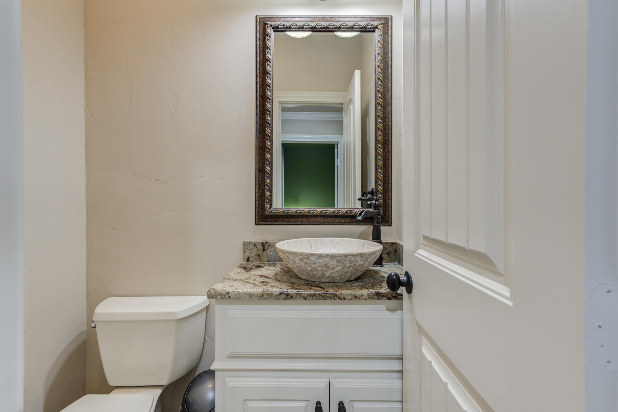 3206 County Road 7610 Lubbock, TX 79423 - Photo 58 of 93 a bathroom with a granite countertop sink and a toilet