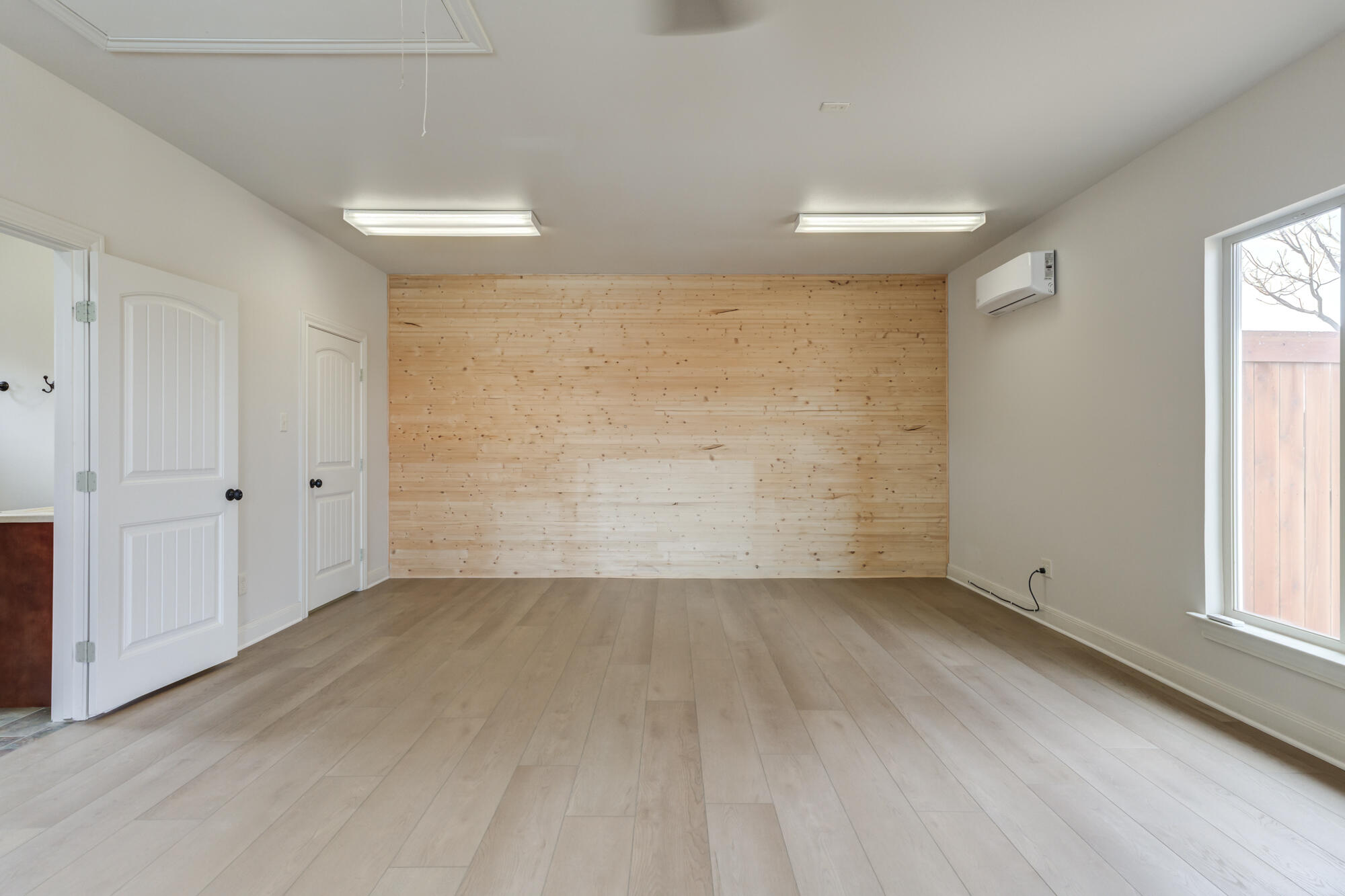 3206 County Road 7610 Lubbock, TX 79423 - Photo 63 of 93 wooden floor in an empty room with a window