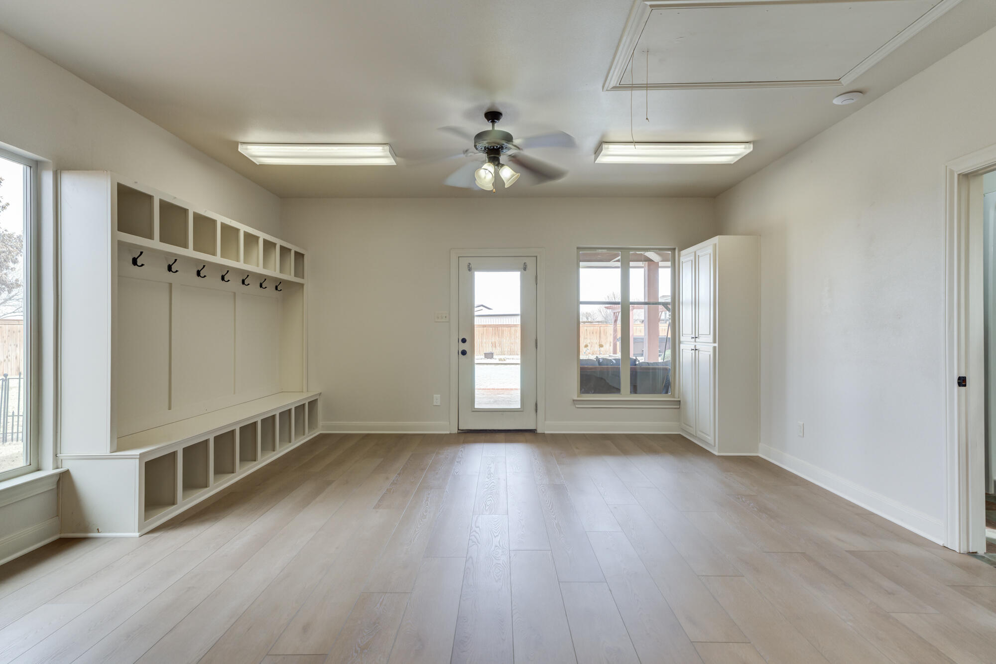 3206 County Road 7610 Lubbock, TX 79423 - Photo 65 of 93 a view of an empty room with a window and wooden floor